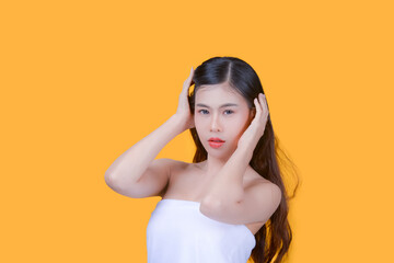 Beauty and healthcare. Portrait of young and beautiful asian woman on yellow background