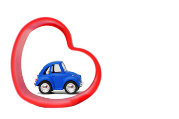 .Blue  toy car with red heart on white isolated background. Valentine's Day. Copy Space