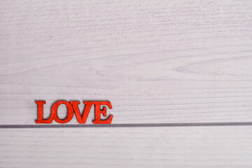 the inscription love on a wooden background. layout. High quality photo