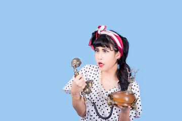 Closeup blackhead young woman pretty pinup girl retro vintage 50's style in button shirt making...