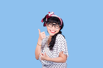 Vision. Closeup attractive fashion cute pinup girl wearing eyeglasses woman holding pair of glasses taking them off she does not need anymore surgical correction of eyesight concept blue background