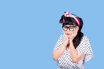 Vision. Closeup attractive fashion cute pinup girl wearing eyeglasses woman holding pair of glasses taking them off she does not need anymore surgical correction of eyesight concept blue background