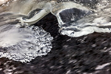 Fast river with ice and snow in late autumn