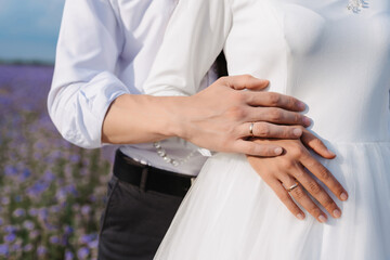 hands of the bride and groom with gold wedding rings