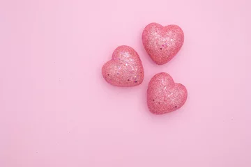 Fotobehang Figures of the glittery hearts on pink background. St. Valentine's Day design. © Diana