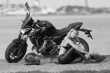 Fototapeta na wymiar young woman with a sports motorcycle