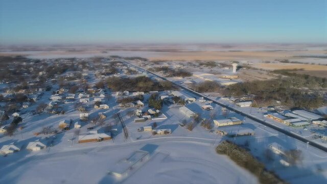 Aerial of a Small Snowy Town with Water Tower