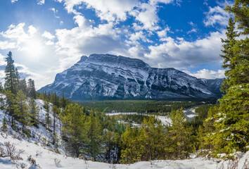 Banff National Park beautiful mountain landscape. Panorama view Mount Rundle valley forest and Bow River in snowy autumn sunny day. Hoodoos Viewpoint, Canadian Rockies.