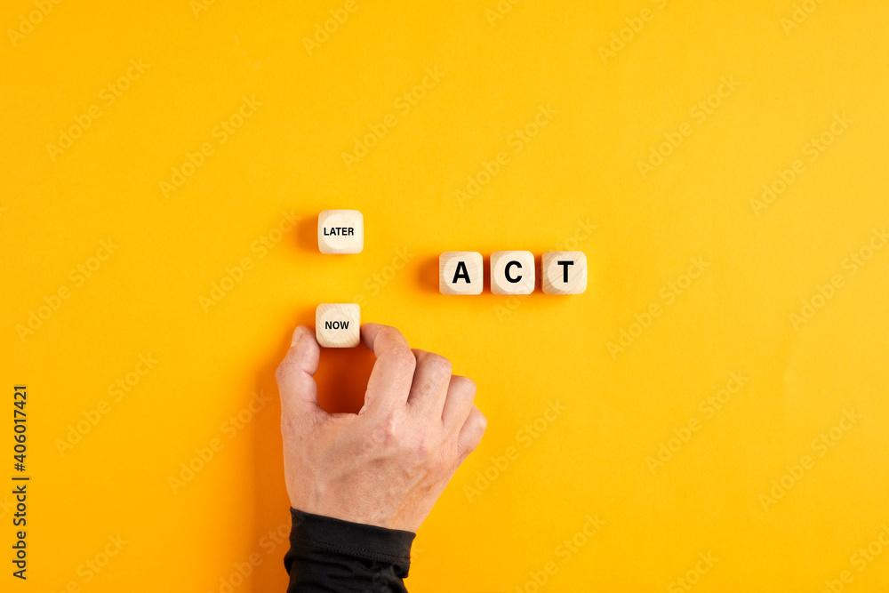 Wall mural The word act on wooden blocks with a male hand choosing the now option. Taking action