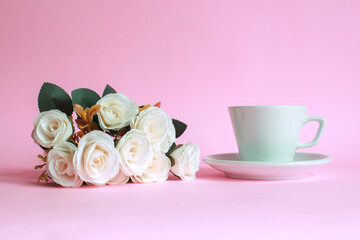 Cup of coffee with rose isolated on pink background