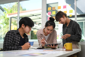 Them of creative designer discussing together on new project in modern conference room.