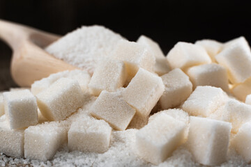 Refined sugar and sugar on a dark background. Sugar on burlap