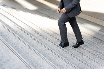 Close up businessman walking stepping up on business district urban, business concept