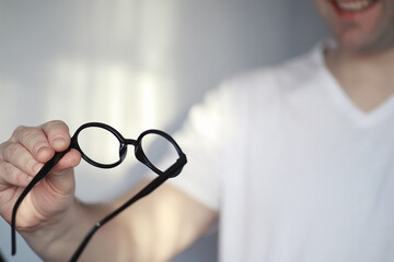 The concept of poor vision. Hold a contact lens and glasses in hand. A poster for advertising...