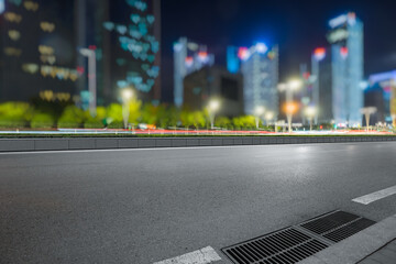 urban traffic road with cityscape in background at night