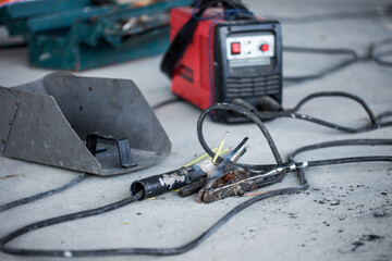 Set of an inverter welding machine with a welding shield, welding ground clamp, and electrode holder