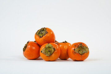 Delicious fresh persimmon fruit isolated on white background. Organic goldcrest. Copy space. Food market. Product for sale. 