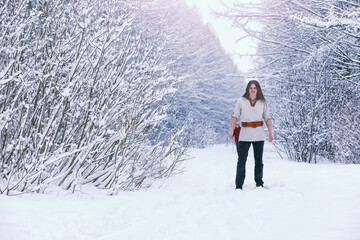 Bearded man in the winter woods. Attractive happy young man with beard walk in the park.