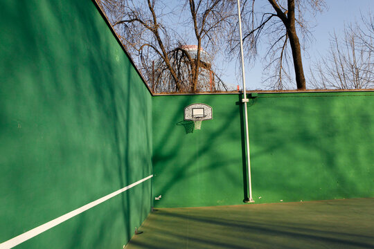 A picture of Basketball court on a green wall 
