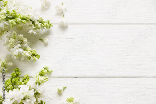 Lilac  blooming branches  on white wooden board.  Spring template . Spring background with empty space for Mother's day, women's day, 8 march, birthday, easter, wedding invitation