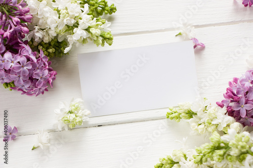 Lilac  blooming branches  on white wooden board.  Spring template . Spring background with empty card for Mother's day, women's day, 8 march, birthday, easter, wedding invitation