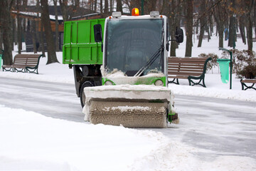 machine for cleaning snow on a city street cleans the road