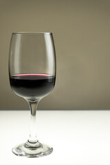 Glass of red wine on a blurred background.Vertical photo