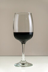 Glass of red wine on a blurred background.Vertical photo