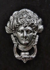 Silver coated antique person door knoker