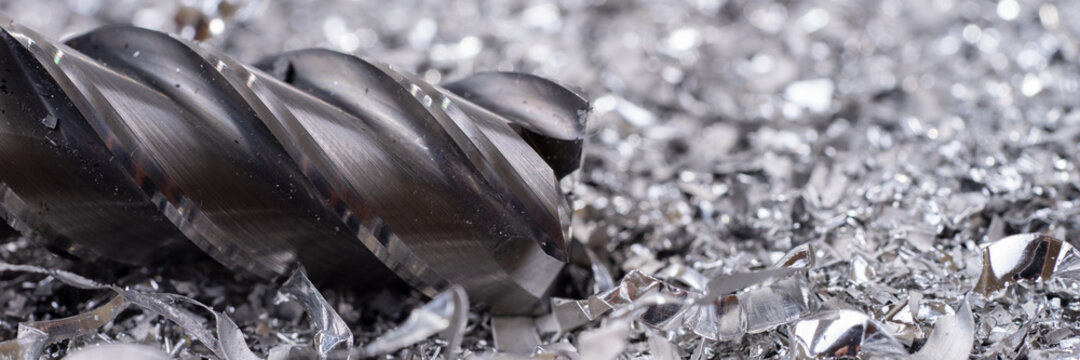 Panoramic Image. Silver End Mill Cutter With Metal Shavings. Processing Of Ferrous Metals In A Factory