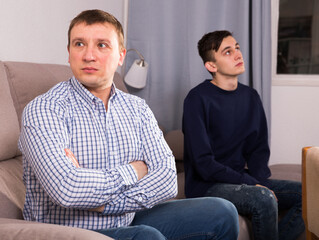 Fototapeta premium Man is offended and son is not wanting talking with him at the home.