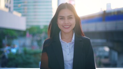 Portrait of a young business woman is smiling in city . Business people , confident people concept..