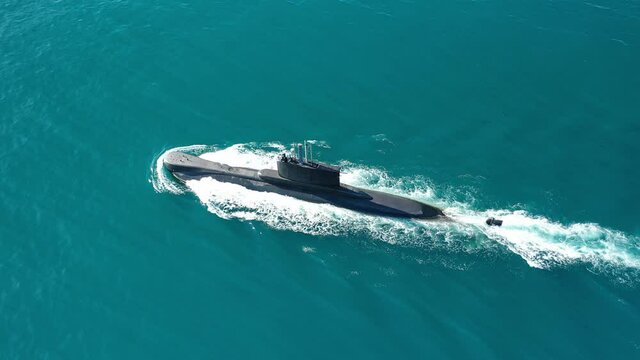 Aerial drone video of latest technology armed diesel powered submarine cruising half submerged