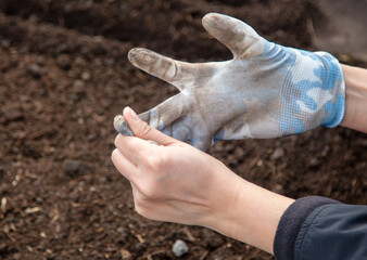 The girl puts gloves on her hands