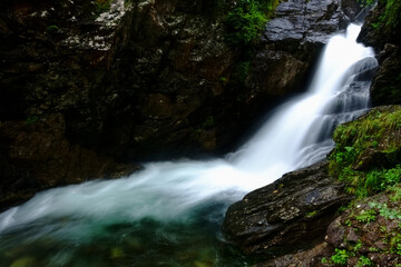 Obraz premium soft flowing little waterfall in the mountains