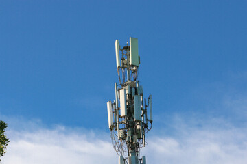 Telecommunication tower mast on sky background. Cellular telephone network or Digital wireless connection system. Receiving station Antenna