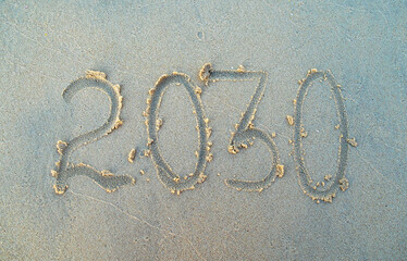 New year, number 2030 on beach sand. Holiday concept. 2030 plan
