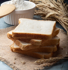 Sliced bread. Toast bread on burlap. Bread made from wheat flour.