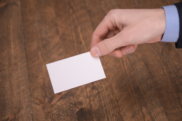 Hand hold blank white card mockup with rounded corners. Plain call-card mock up template holding...