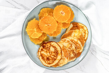 American Pancakes and Orange Slices on Marble Background