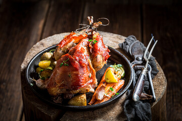 Roasted pheasant with vegetables, bacon and herbs