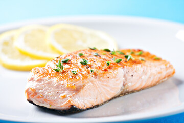 Fillet of salmon with asparagus on a plate.