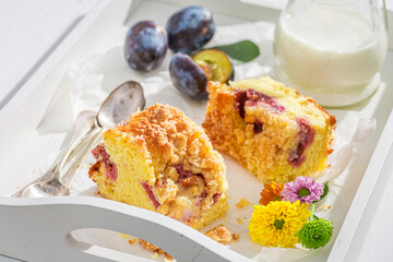 Homemade and tasty plum cake on white table