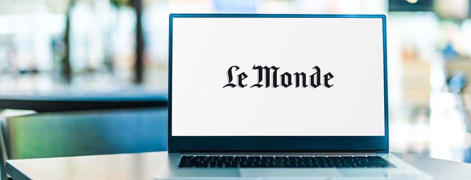 Laptop Computer Displaying Logo Of Le Monde