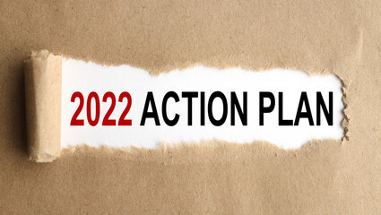 2022 action plan, text on white paper with torn paper background