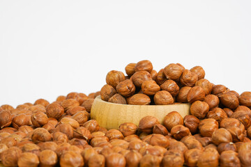 Peeled Hazelnuts on white background. Nuts in wooden bowl isolated on white background.  Healthy food for dieting or snack.  Copy space.  Studio shot.