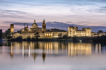 Mantova skyline reflected in Mincio lake at sunset, Lombardia, Italy