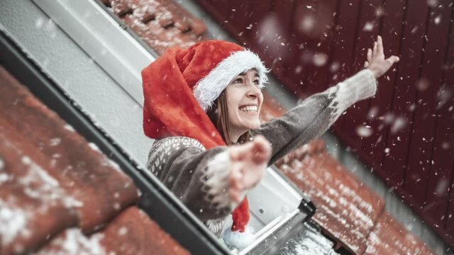 Young Woman Happy of a Snow in her Rooftop Room. Still Picture with Moving Snow. Looping. Cinemagraph.