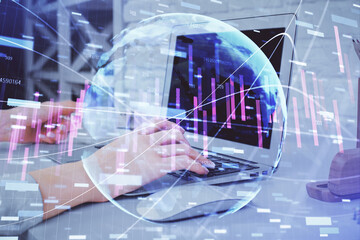 Double exposure of woman hands typing on computer and forex chart hologram drawing. Stock market analysis concept.