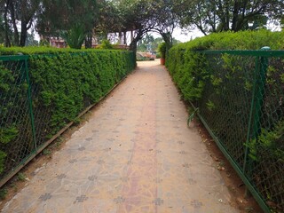 stone paved pathway and green fence, Napier museum Trivandrum, Kerala